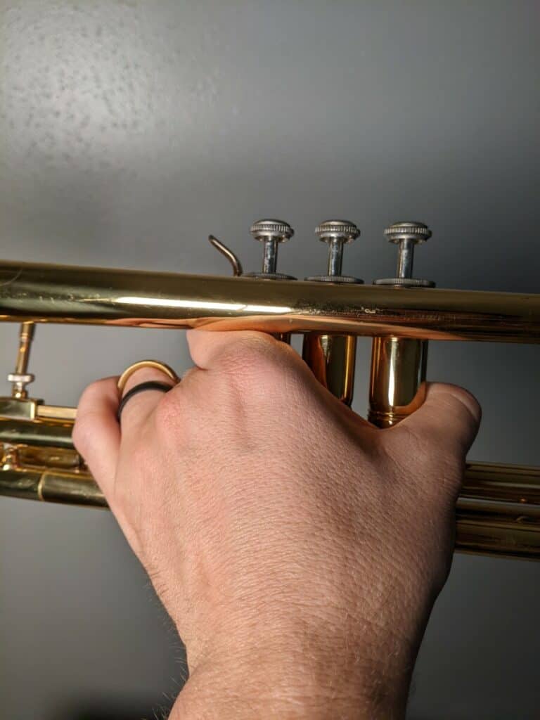 left hand holding trumpet